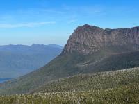 A mountain sloping down to join a lake