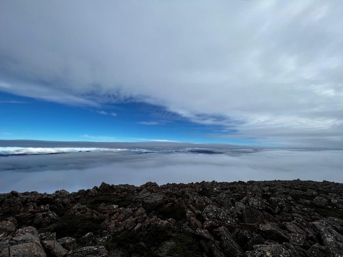 Foreground of rocks with cloud in the back part of the photo