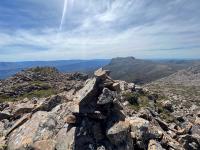 A pile of rocks on the top of a mountain